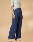 Women’s navy blue wide-leg linen trousers, side view, elastic drawstring waist