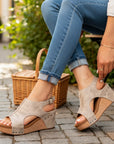 Beige distressed leather open-toe wedge sandals with studded straps