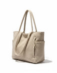 Corduroy tote bag in beige with ribbed fabric, two top handles, and front pocket