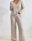 Light beige ribbed knit V-neck top with wide-leg trousers, full length