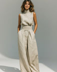 Beige sleeveless high-neck tank top with wide-leg trousers set, draped waist