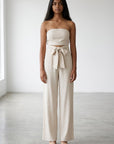 Beige strapless wide-leg jumpsuit with bow-tied waist and straight legs