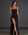 Black evening maxi dress with square neckline and thigh-high side slit