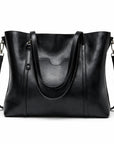 Black leather tote bag with curved top handle, front pocket, and shoulder strap