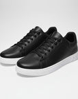 Black leather low-top trainers with lace-up front and white rubber sole