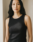 Black sleeveless ribbed knit midi dress with crew neckline, fitted silhouette.