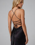 Black satin maxi dress back view with crisscross straps and lace-up detail