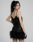 Black sequin mini dress with spaghetti straps and feather fringe hem