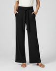 Black relaxed wide-leg trousers with tie waist and draped front.