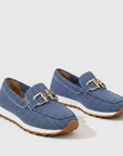 Pair of blue slip-on loafers with gold bit hardware and tan rubber outsole.