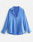 Light blue long-sleeve button-up blouse with pointed collar and front button placket
