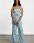 Light blue strapless wide-leg jumpsuit with ruched top and bow tie