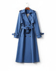 Blue trench coat with double-breasted styling, belted waist, and long sleeves.