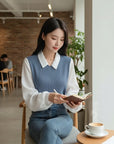 Blue V-neck knit blouse with white collar and long sleeves