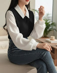 Black V-neck knit blouse with white collar and long sleeves