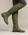 Green leather knee-high boots with side buckle straps and low stacked heel