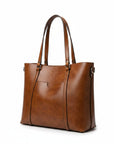 Cognac leather tote bag with two top handles, structured sides, and metal hardware