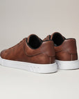 Brown low-top trainers, rear view, cushioned heel and white sole