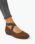 Brown wedge ballet flats with ankle strap and cross straps, closed toe.