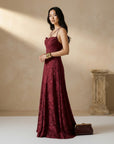 Burgundy jacquard maxi dress with spaghetti straps, fitted bodice, and full skirt