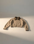 Cropped beige cardigan with leather-like turn-down collar and full-zip front