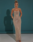 Embellished evening gown with square neckline, sleeveless straps, and long column fit in champagne-silver.