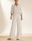 White button-front blouse and wide-leg trousers set with rolled sleeves