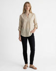 Beige linen blouse with V-neck and partial button placket, three-quarter rolled sleeves.