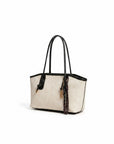 Off-white and black tote bag with long handles and braided tassel charm