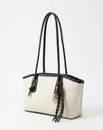 Off-white tote bag with black handles and braided tassel key charm