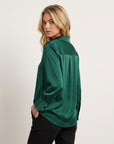 Women’s long-sleeve blouse in deep green, back view with relaxed shoulder fit