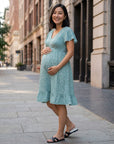 Teal floral maternity dress with V-neck and flutter sleeves, knee-length
