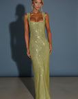 Green embellished evening gown with square neckline and sleeveless silhouette