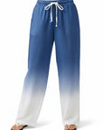 Blue-to-white ombre wide-leg linen pants with elastic waist and white drawstring ties.