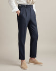 High-waisted tailored trousers in dark navy, pleated front, belt loops