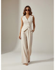 Women’s cream sleeveless co ord set with V-neck wrap waistcoat and flowing wide-leg trousers