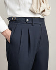 High-waisted tailored trousers in dark navy, pleated front and belt buckle