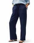 Navy wide-leg linen pants with elastic waist and drawstring, relaxed full-length leg openings.