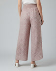 Pink printed wide-leg trousers with elastic waist and drawstring, full length