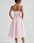 Back view of pink gingham midi dress with corset-laced bodice and low open back