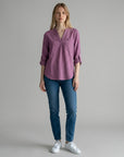 Purple linen blouse with V-neck and small button placket, three-quarter sleeves rolled up.