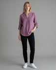 Mauve purple linen blouse with V-neck and button placket, three-quarter sleeves rolled up.