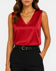 Red satin sleeveless V-neck blouse with draped front and slim fit.