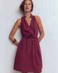 Sleeveless short dress with V-neck, gathered bodice, and tie waist in burgundy