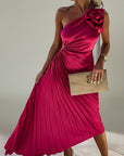 Fuchsia one-shoulder pleated maxi dress with rosette detail at the shoulder
