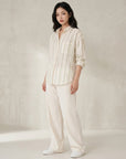 Cream striped button-up shirt with blue vertical stripes, collar, and long sleeves.