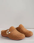 Tan slip-on slippers with curved metal buckle and perforated leather-style top.