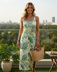 Cream sleeveless sundress with blue-green leaf print and scoop neckline.