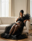 Black sheer tulle maternity gown with wide tulle sleeves and flowing layered skirt