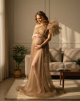 Beige sheer tulle maternity dress with sheer puff sleeves and long flowing skirt